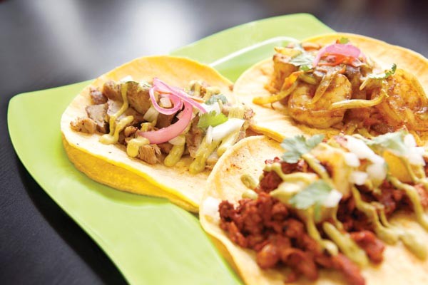 A trio of tacos: carnitas, pastor and curried shrimp
