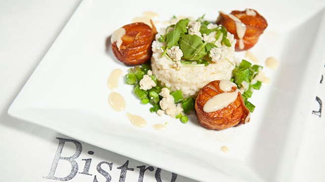 Bacon-wrapped scallops with blue-cheese risotto, sugar snap peas and garlic-cream sauce