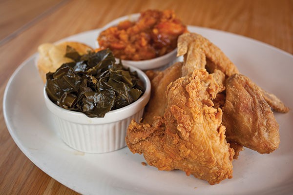 Fried chicken wings with greens, sweet potato and cornbread