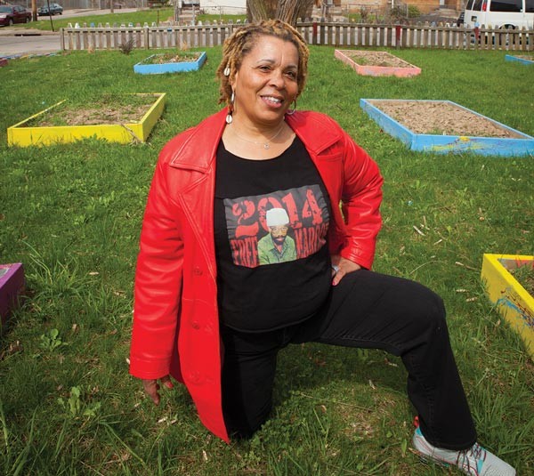 Gardener and activist Ayanna Rauf poses at The Murtland Avenue Garden near Westinghouse High School, in Homewood.