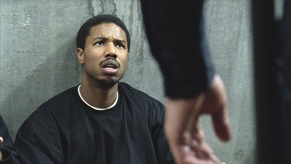 Oscar Grant (Michael B. Jordan) is detained by BART police.
