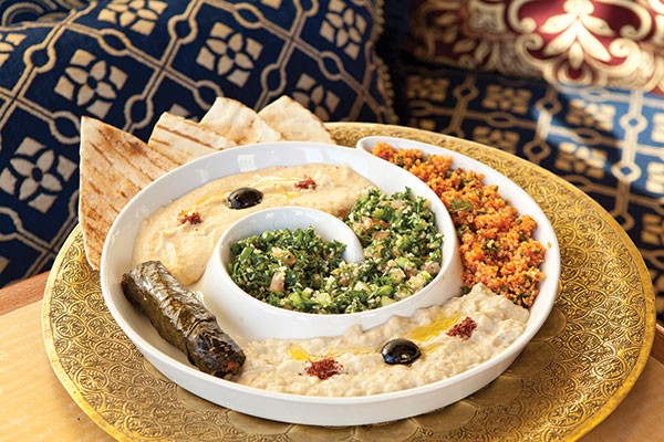 Starter selection including: hummus, baba ghanoush, stuffed grape leaves, tabuleh and red tabuleh