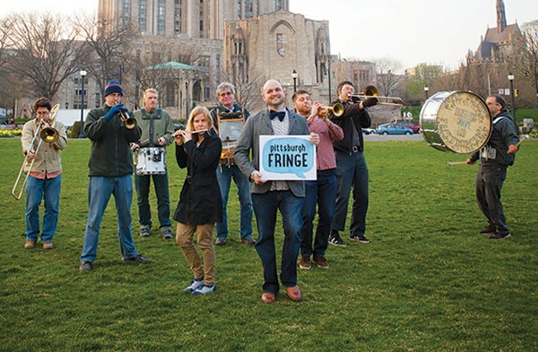 Theatrical outlier: Fringe Festival founder Dan Stiker poses earlier this month with musicians in Schenley Plaza.