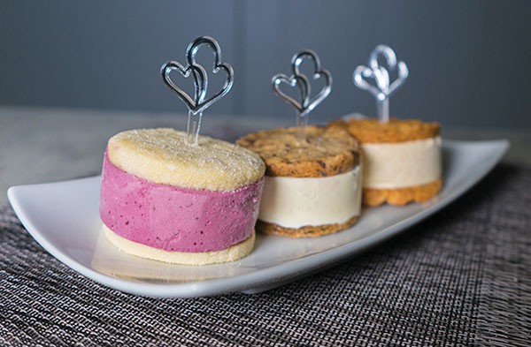 Top Leona's Ice Cream Sandwiches with heart-shaped cupcake toppers for a unique alternative to cake.