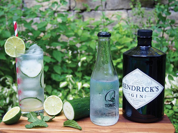 A gin-and-tonic, garnished with cucumber, lime and mint, is a refreshing summer cocktail.