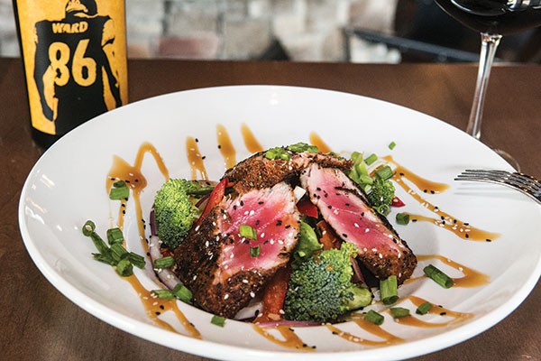 Blackened thick-cut ahi tuna, with a light caramel drizzle, served with rice and stir-fried vegetables