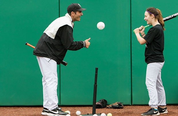 Camp coaches work with hard-of-hearing students on batting, throwing, running and catching in PNC Park’s outfield.