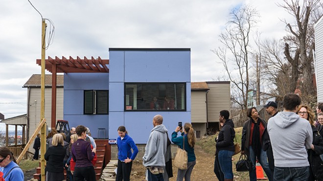 Residents line up to view the completed tiny house in Pittsburgh's Garfield neighborhood