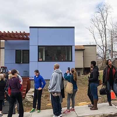 Residents line up to view the completed tiny house in Pittsburgh's Garfield neighborhood