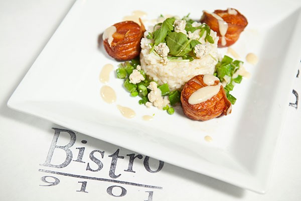 Bacon-wrapped scallops with blue-cheese risotto, sugar snap peas and garlic-cream sauce