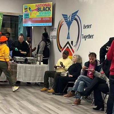 People of different races chat and eat during a National Black HIV Awareness Day event.