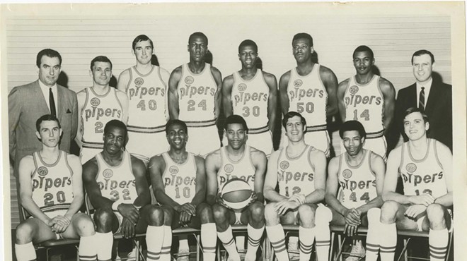 A basketball team with short shorts and high socks in the late '60s.