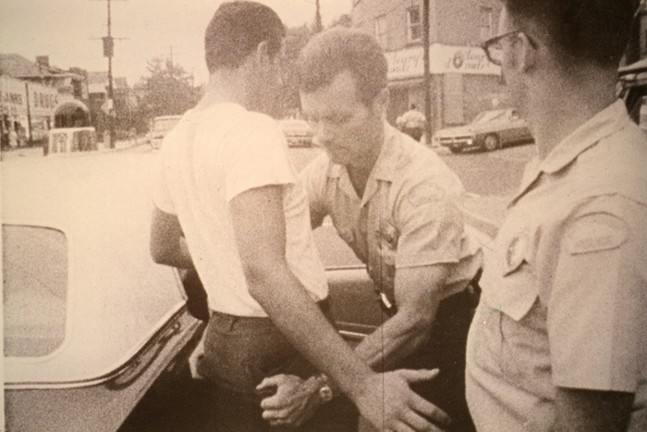A police officer frisks someone in a still from the documentary Pittsburgh Police 1969.