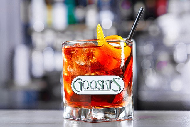 A negroni with a badly Photoshopped Gooskis logo on the glass