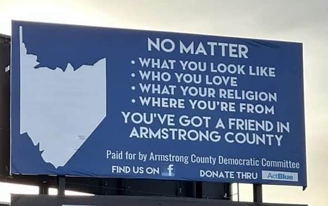A blue billboard that reads "You’ve got a friend in Armstrong County."