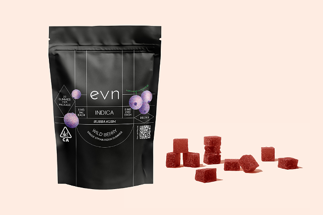 Pale pink background, image of black bag labeled "evn indica bubba kush wild berry", with dark red gummies scattered in the foreground