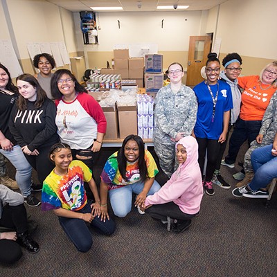 Perry High School librarian Sheila May-Stein and her students at work in the in-school food pantry