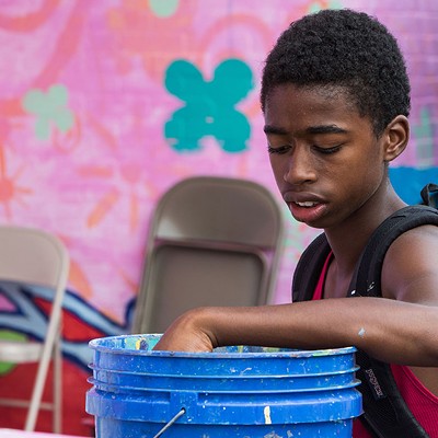 Kids work on a mural project in Homewood